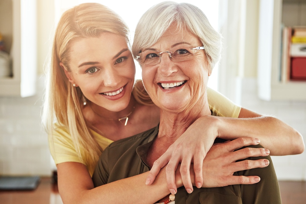 Two generations of women smiling, representing family dental care at Uptown Dentistry in Park Ridge and Morton Grove